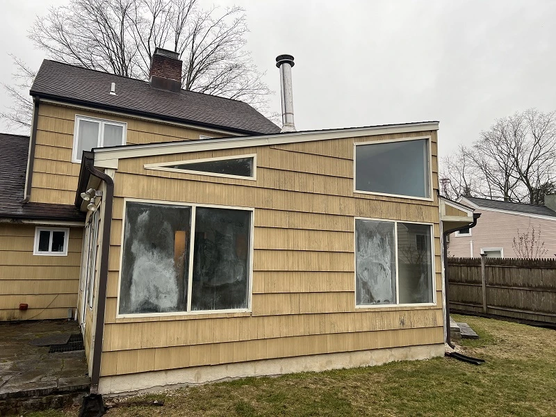 Old aluminum windows on a porch in Norwalk